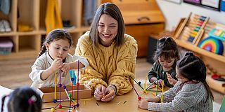 Betreuerin mit Kindern in Kita