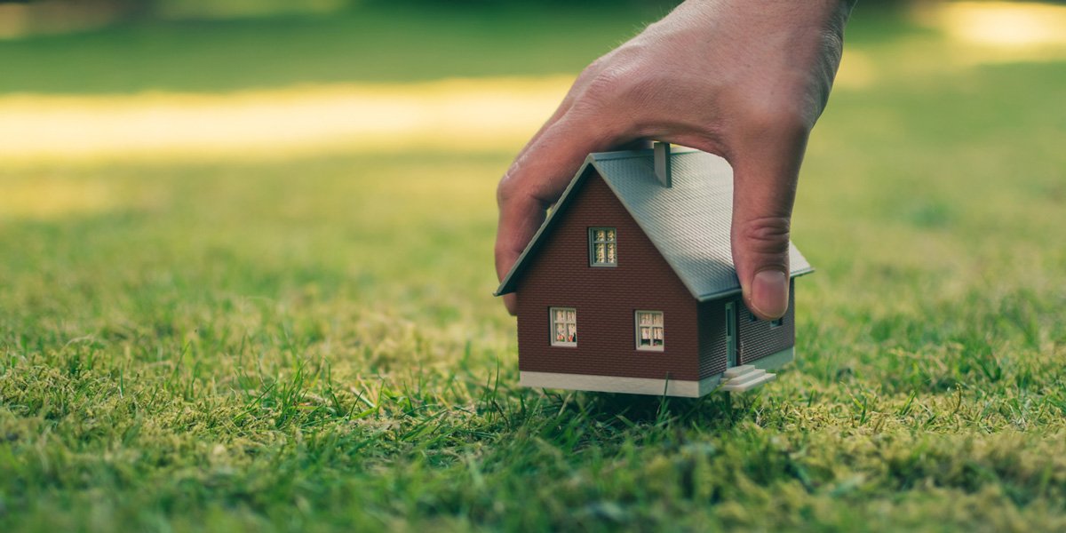Grundstücksrecht Miniatur Haus auf Rasen